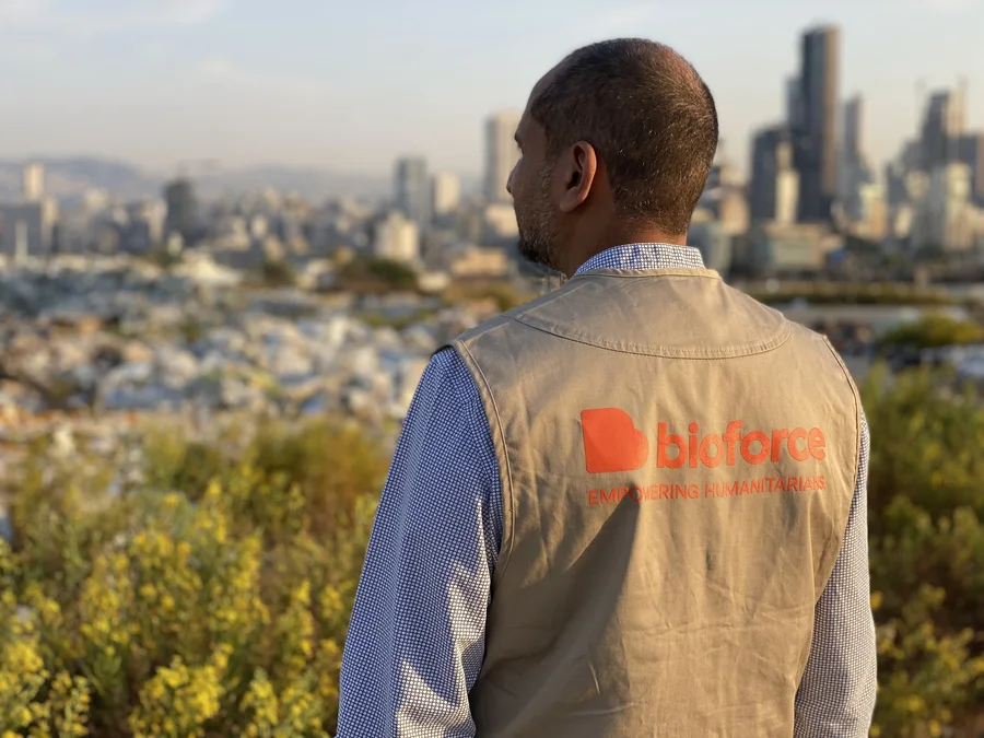 Bioforce humanitarian professional overlooking an urban context